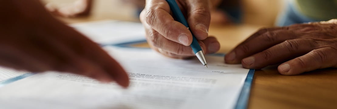 Person signing a document. 